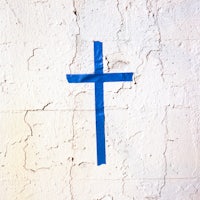 a blue cross painted on a wall